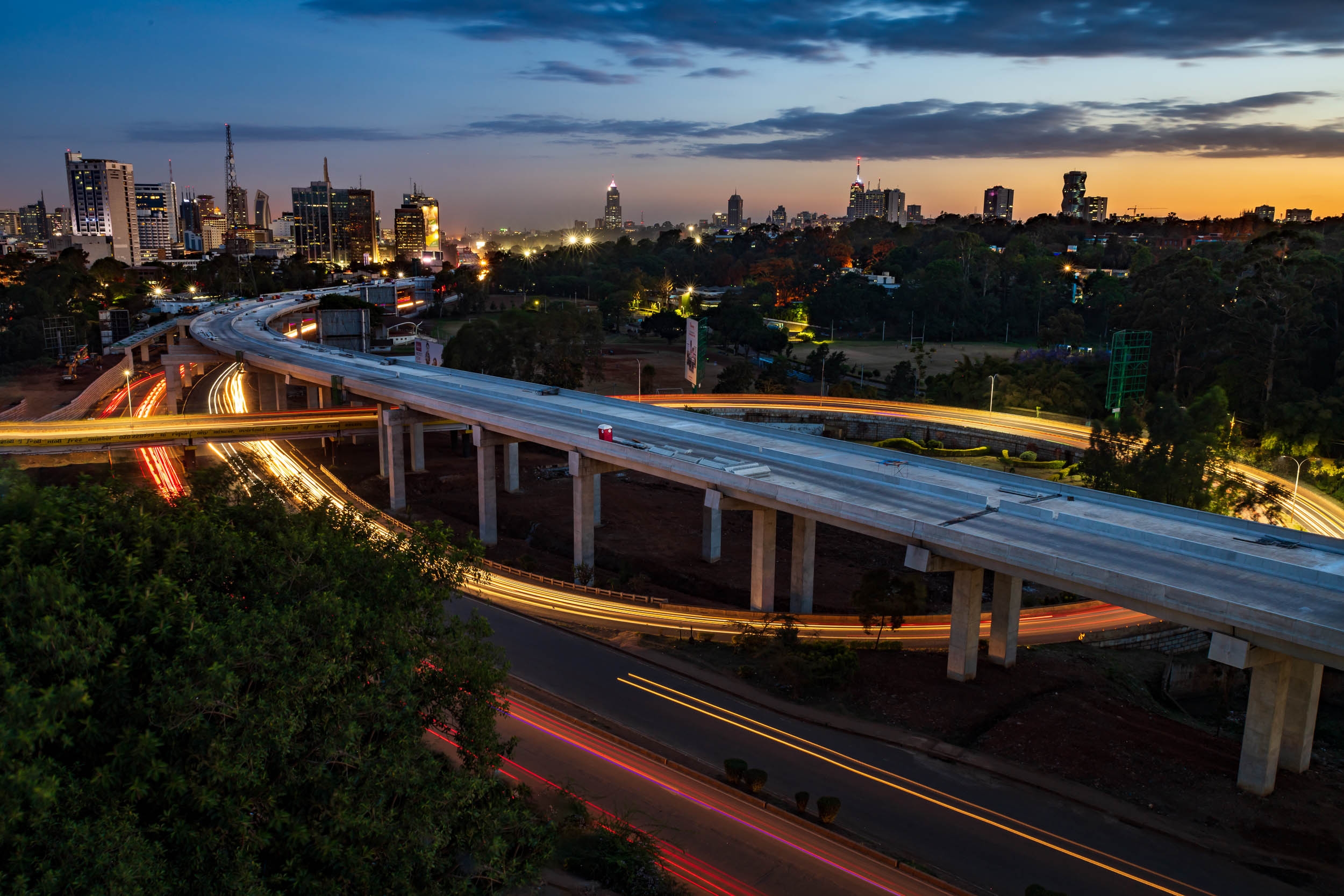 Aerial,View,Of,Nairobi,Skyline,With,Light,Trails,During,Sunset